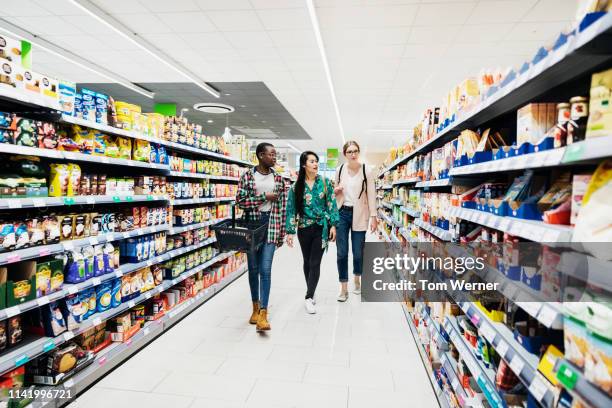 three girls shopping in super market - supermarket indoor foto e immagini stock