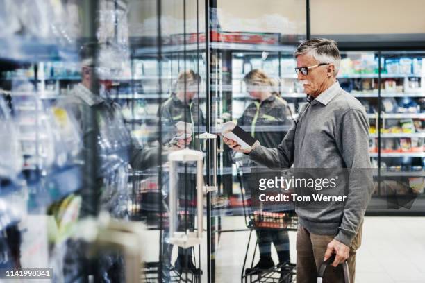 senior man shopping in frozen food section - germany shopping bildbanksfoton och bilder