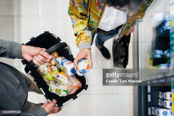 aerial view of senior couple picking out groceries - supermarket foto e immagini stock