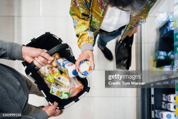 aerial view of senior couple picking out groceries - household products stock pictures, royalty-free photos & images