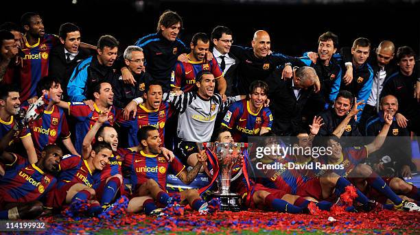 Barcelona players celebrate with the La Liga trophy after the La Liga match between Barcelona and Deportivo La Coruna at Camp Nou Stadium on May 15,...