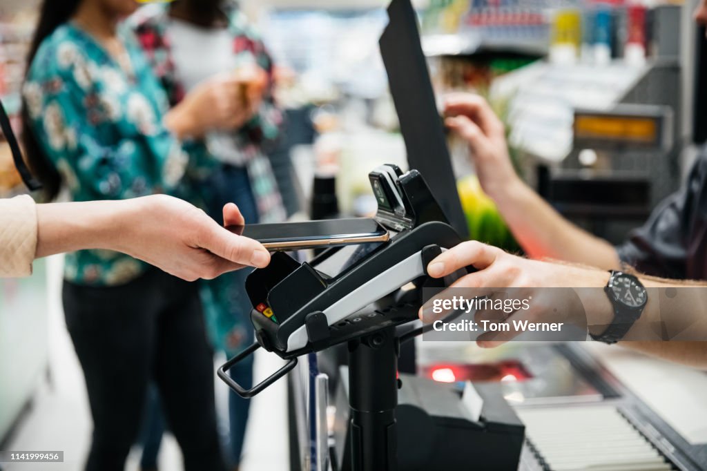 Close Up Of Contactless Payment With Smartphone