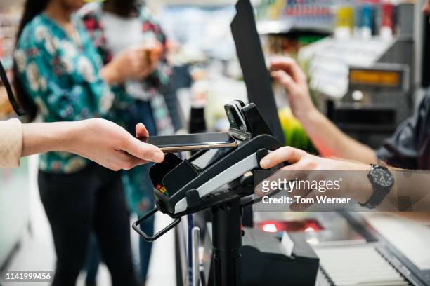 close up of contactless payment with smartphone - paying stock-fotos und bilder