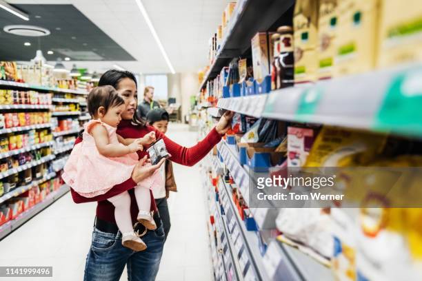 Mother Holding Daughter While Shopping