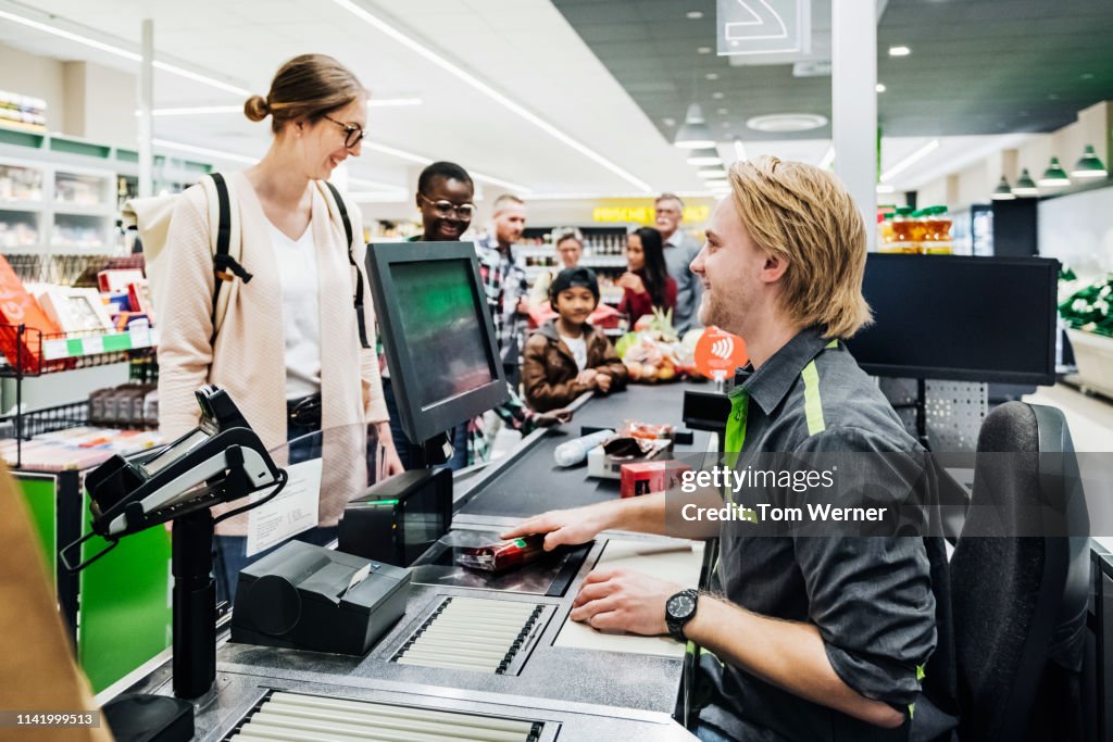 Cashier Ringing Up Customers Groceries