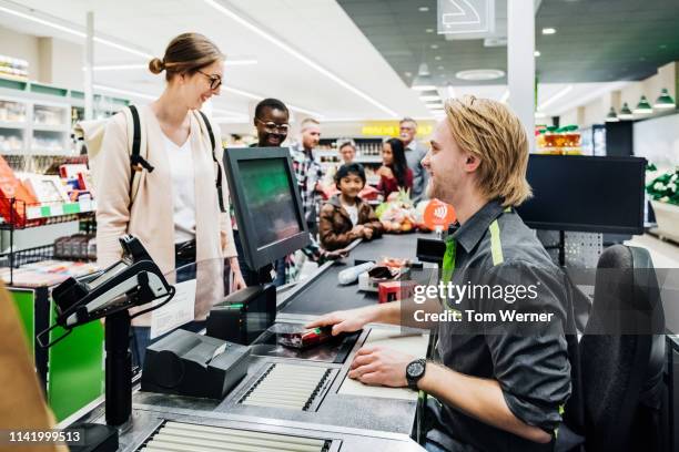 cashier ringing up customers groceries - kassa bildbanksfoton och bilder