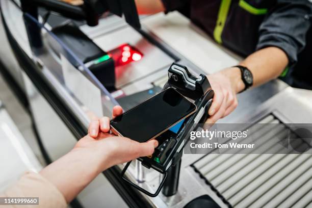 smartphone paying using contactless card reader - credit card reader stock pictures, royalty-free photos & images