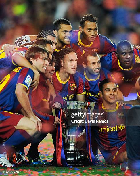 Barcelona players celebrate with the La Liga trophy after the La Liga match between Barcelona and Deportivo La Coruna at Camp Nou Stadium on May 15,...