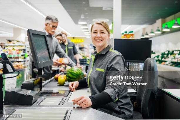 portrait of cashier smiling while working - cashier 個照片及圖片檔
