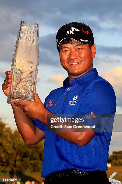 Choi of South Korea celebrates with the trophy after defeating David Toms on the first playoff hole during the final round of THE PLAYERS...