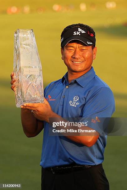 Choi of South Korea celebrates with the trophy after defeating David Toms on the first playoff hole during the final round of THE PLAYERS...