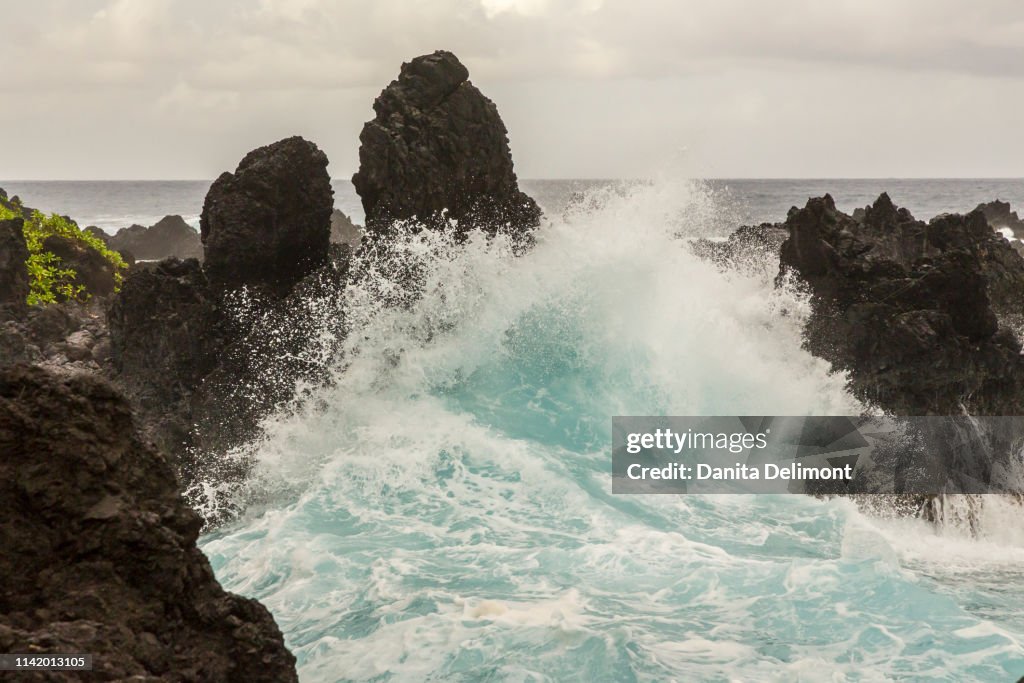 Ocean waves crashing on shore rocks, Laupahoehoe Beach Point State Park, Hawaii, USA