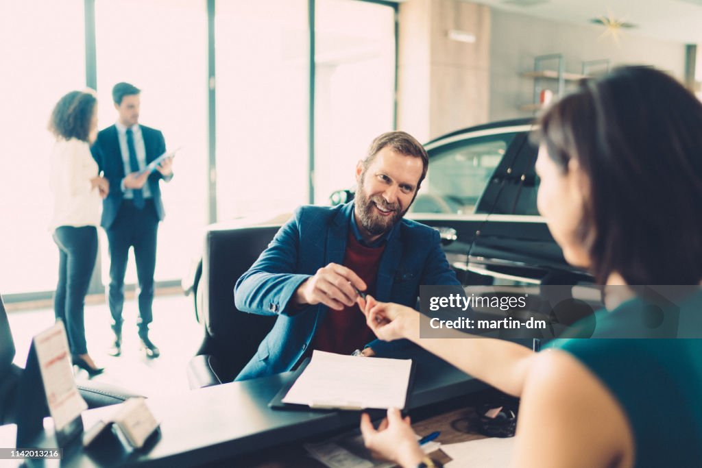 Businessman buying luxury car