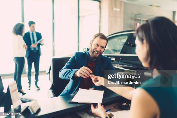 businessman buying luxury car - audi showroom stock pictures, royalty-free photos & images