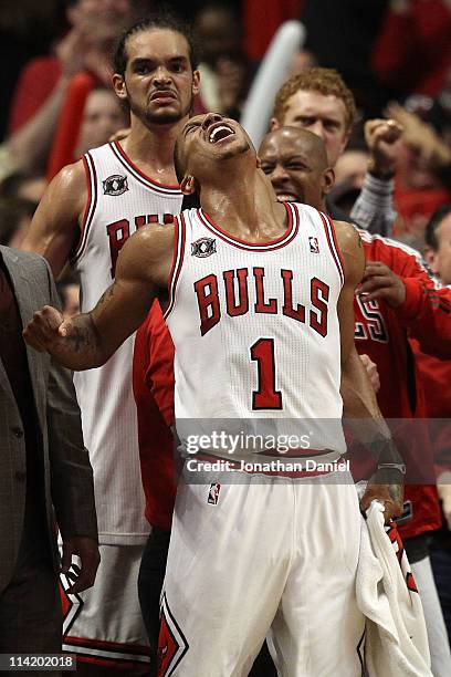 Joakim Noah, Derrick Rose and Keith Bogans of the Chicago Bulls celebrate late in the fourth quarter against the Miami Heat in Game One of the...