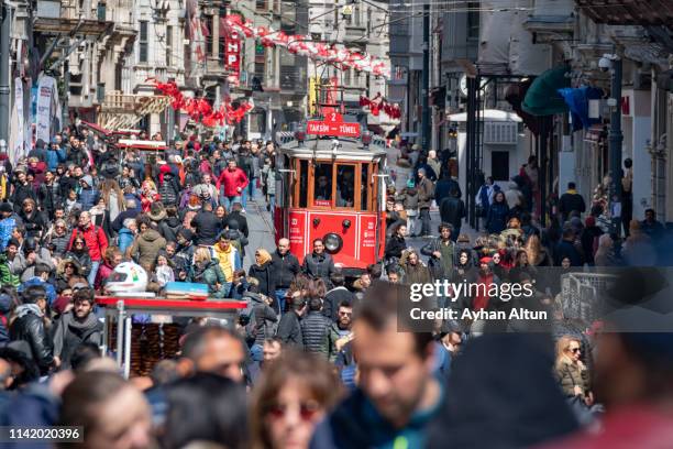 the historical red tramway on the famous istiklal street in beyoglu district of istanbul, turkey - historical istanbul stockfoto's en -beelden