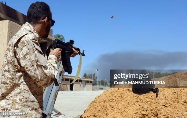 Fighter loyal to the internationally recognised Libyan Government of National Accord keeps position near the Salah al-Din military compound, south of...