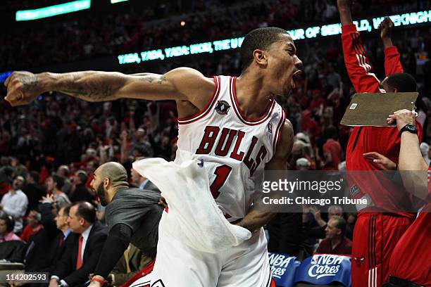 Chicago Bulls point guard Derrick Rose celebrates on the bench after Taj Gibson dunked late in the 4th quarter in Game 1 of the NBA Eastern...