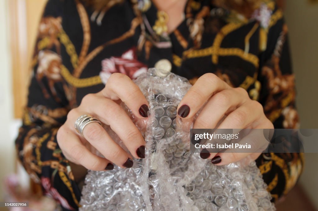 Woman Pupping Bubbles On bubble pack