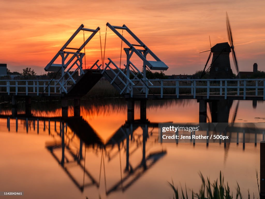Windmill And Bridge In Sundown