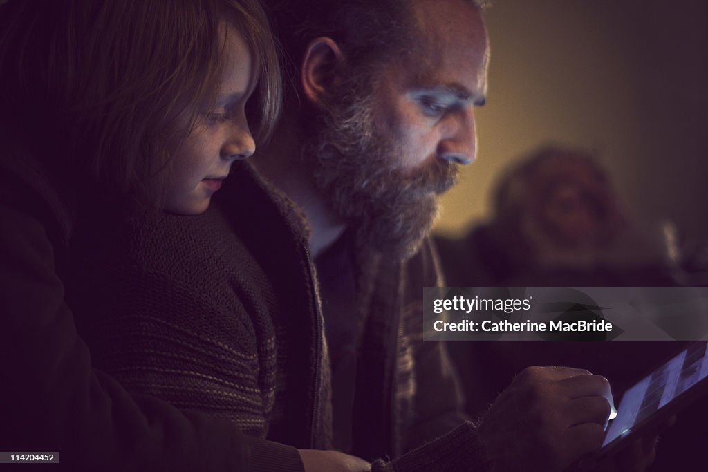 Father and Son bonding over tablet computer