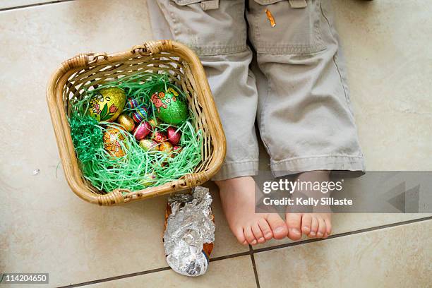 easter basket and little feet - easter basket with candy stock pictures, royalty-free photos & images