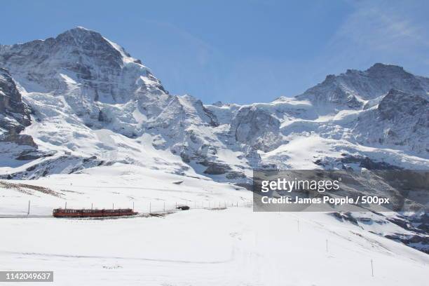 landscape of snowcapped mountains - james popple stock pictures, royalty-free photos & images