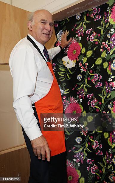 Vince Cable MP, Secretary of State for Business, tries out a 'You Can Do It' DIY class on a visit to B&Q in Sutton on a visit to the store to launch...