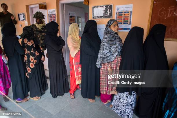 April 11: Kashmiri women wait in queue to cast their ballots outside the polling station, during the first phase of the elections of the lower house...