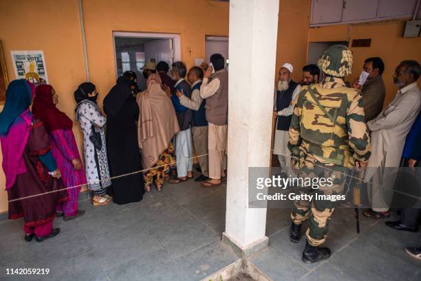 April 11: Kashmiri men and women wait in a queue to cast their ballots outside the polling station, during the first phase of the elections of the...