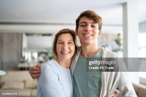 portrait of grandson with grandmother - teenager parent stock pictures, royalty-free photos & images