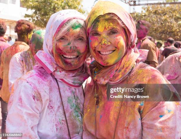 female tourists at hindu holi festival in india. - woman holi stock pictures, royalty-free photos & images