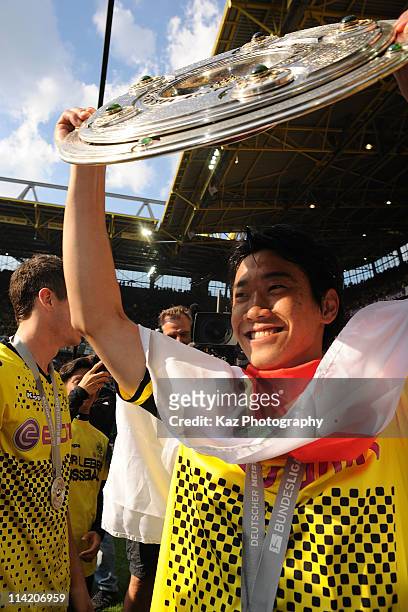 Shinji Kagawa of Borussia Dortmund holds the German Champions trophy after the Bundesliga match between Borussia Dortmund and Eintracht Frankfurt at...