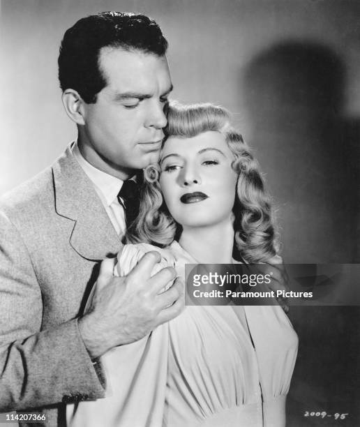 American actors Fred MacMurray and Barbara Stanwyck in a publicity still for 'Double Indemnity', directed by Billy Wilder, 1944.