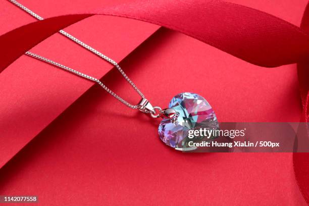 close-up of crystal necklace - heart necklace stock pictures, royalty-free photos & images