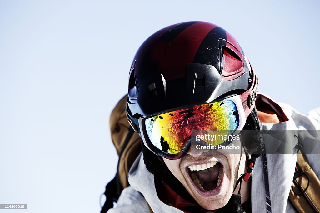 Close up of a skier with helmet screaming