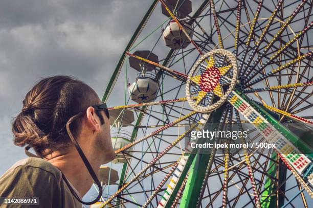 watching the ferris wheel - ipek morel stock pictures, royalty-free photos & images