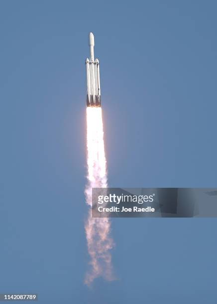 The SpaceX Falcon Heavy rocket is seen after it left launch pad 39A at NASA’s Kennedy Space Center on April 11, 2019 in Titusville, Florida. The...