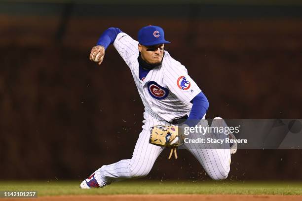 Javier Baez of the Chicago Cubs makes a throw to first base during the fourth inning against the Pittsburgh Pirates at Wrigley Field on April 11,...