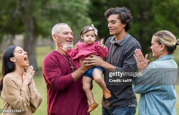 multi-generation hispanic family, playing with baby - happy smiling people multi generations stock pictures, royalty-free photos & images