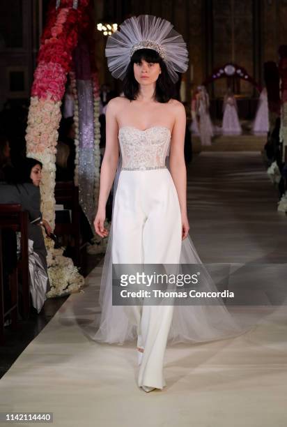 Model walks the runway wearing Reem Acra Bridal on April 11, 2019 in New York City.