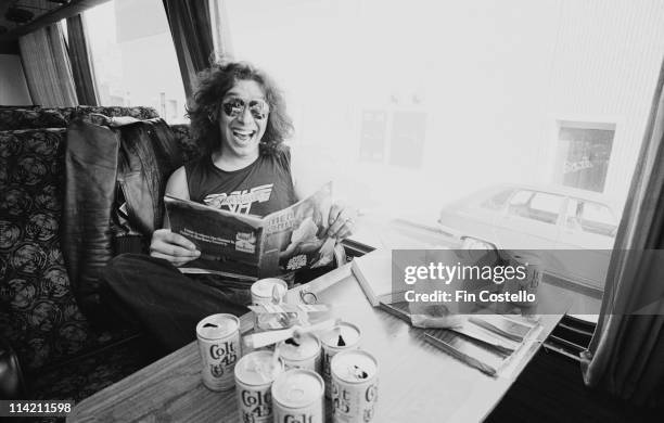 Alex Van Halen from Van Halen reads a magazine on their tour bus outside Lewisham Odeon in London on 27th May 1978.