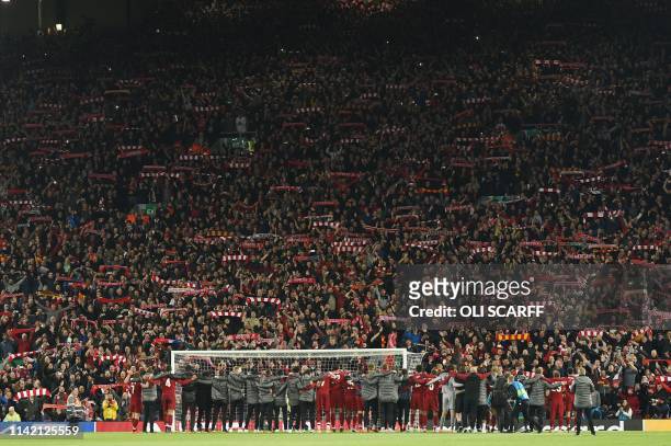 Liverpool squad and backroom staff celebrate in front of the Kop after winning the UEFA Champions league semi-final second leg football match between...
