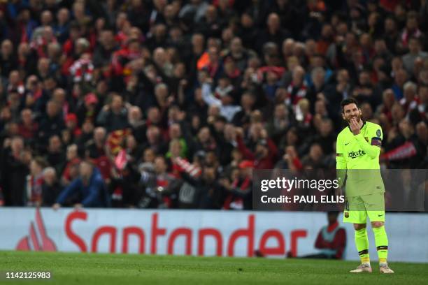 Barcelona's Argentinian striker Lionel Messi reacts after losing the UEFA Champions league semi-final second leg football match between Liverpool and...