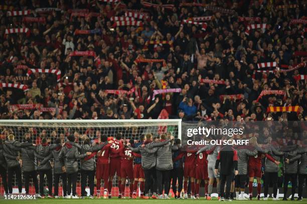 Liverpool players celebrate in front of the Kop after winning the UEFA Champions league semi-final second leg football match between Liverpool and...