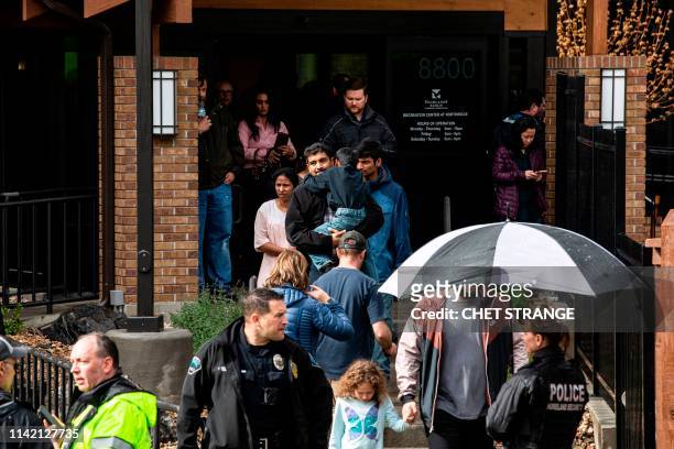Students are evacuated from the Recreation Center at Northridge in Highlands Ranch after a shooting at the STEM School Highlands Ranch on May 7,...