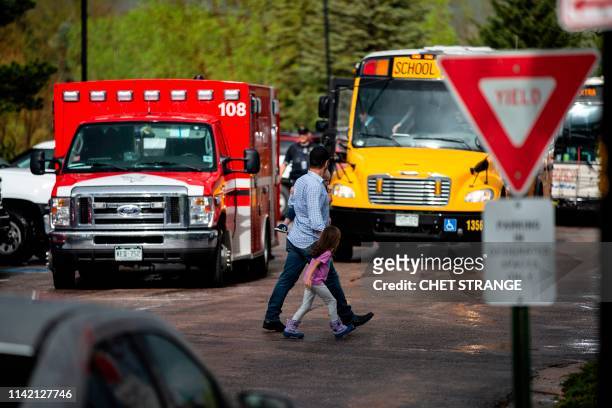 Students are evacuated from the Recreation Center at Northridge in Highlands Ranch after a shooting at the STEM School Highlands Ranch on May 7,...