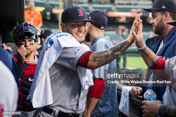 Hector Velazquez of the Boston Red Sox high fives teammates before a game against the Baltimore Orioles on May 7, 2019 at Oriole Park at Camden Yards...