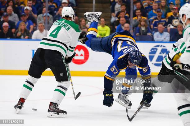 David Perron of the St. Louis Blues looses control of the puck against Miro Heiskanen of the Dallas Stars in Game Seven of the Western Conference...