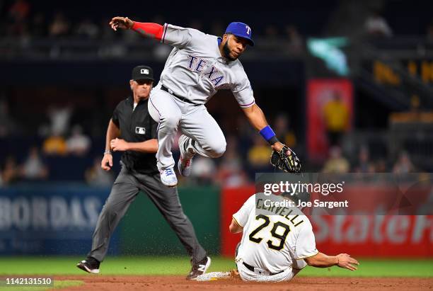 Francisco Cervelli of the Pittsburgh Pirates safely steals second base in front of Elvis Andrus of the Texas Rangers at PNC Park on May 7, 2019 in...